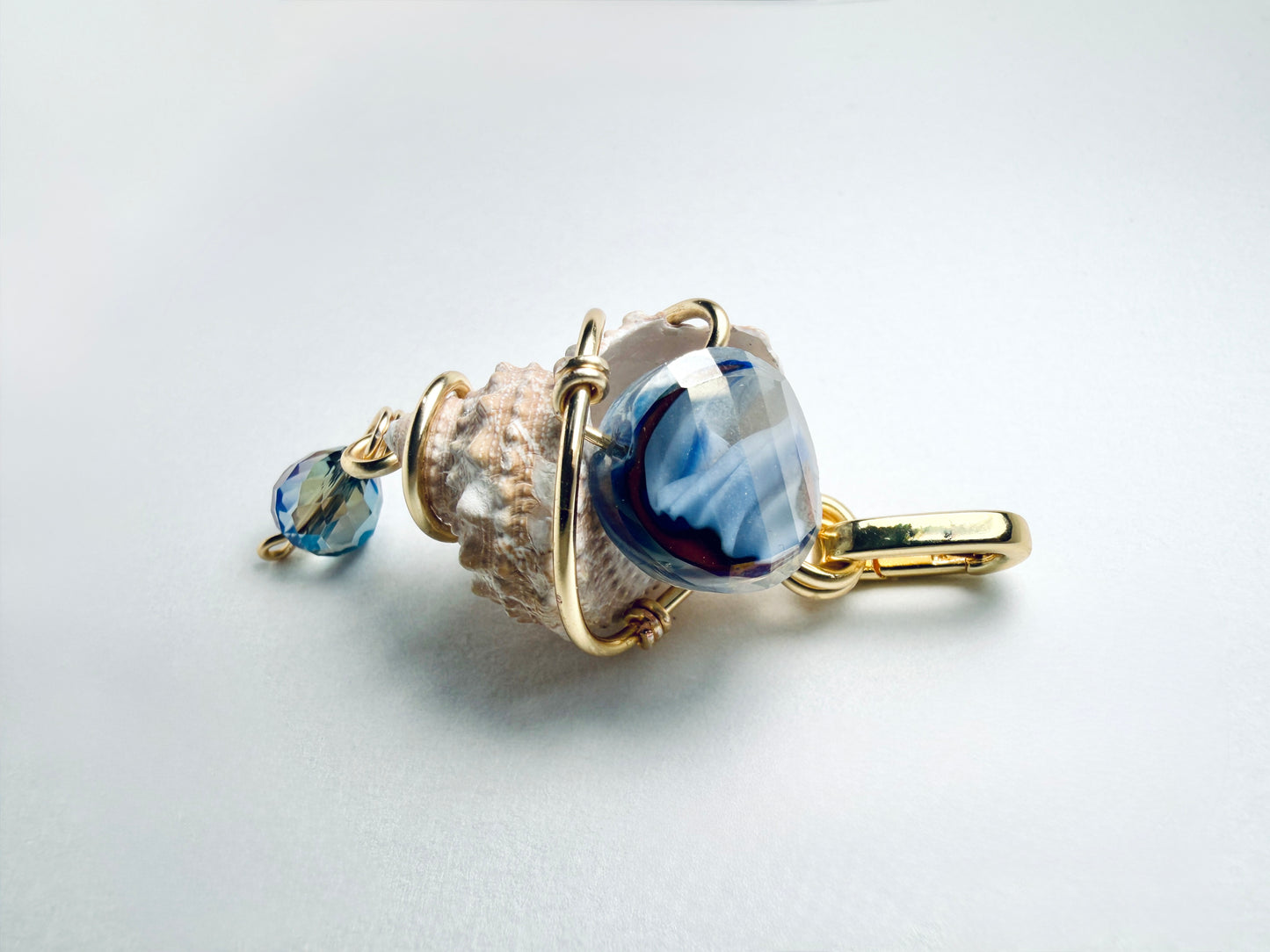 The Tide Caller — Snail Shell Charm w/ Blue Glass Jewel